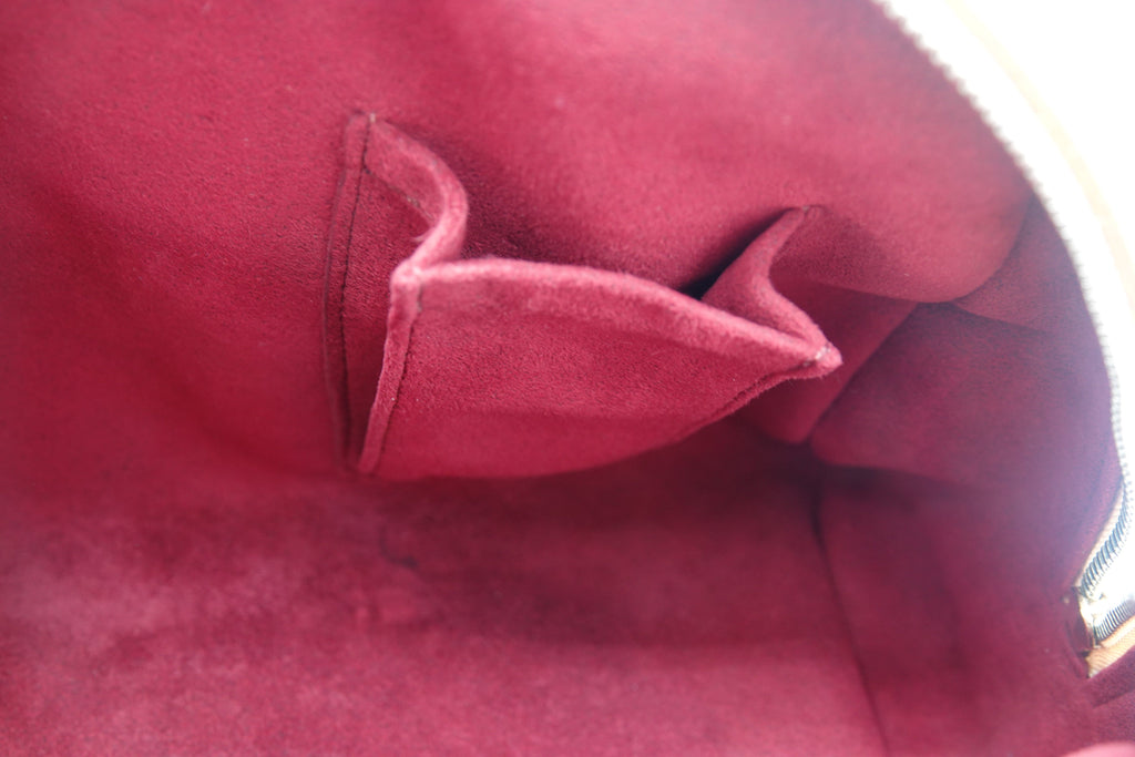 Close-up of a red fabric with a visible seam