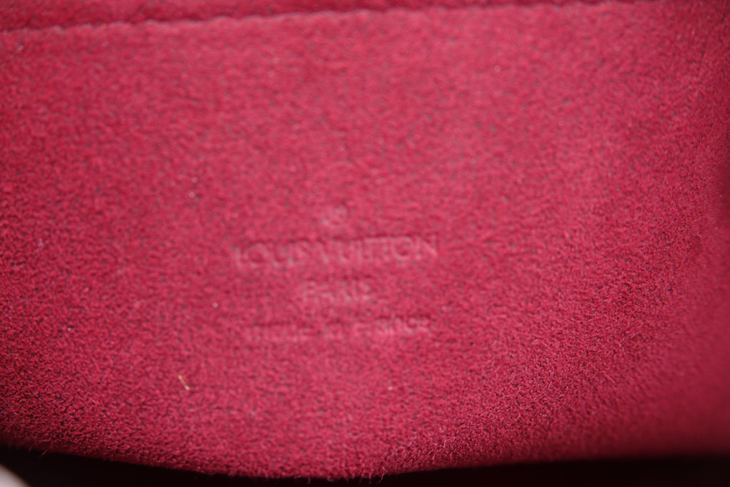 Close-up of a textured red surface with a brand logo.