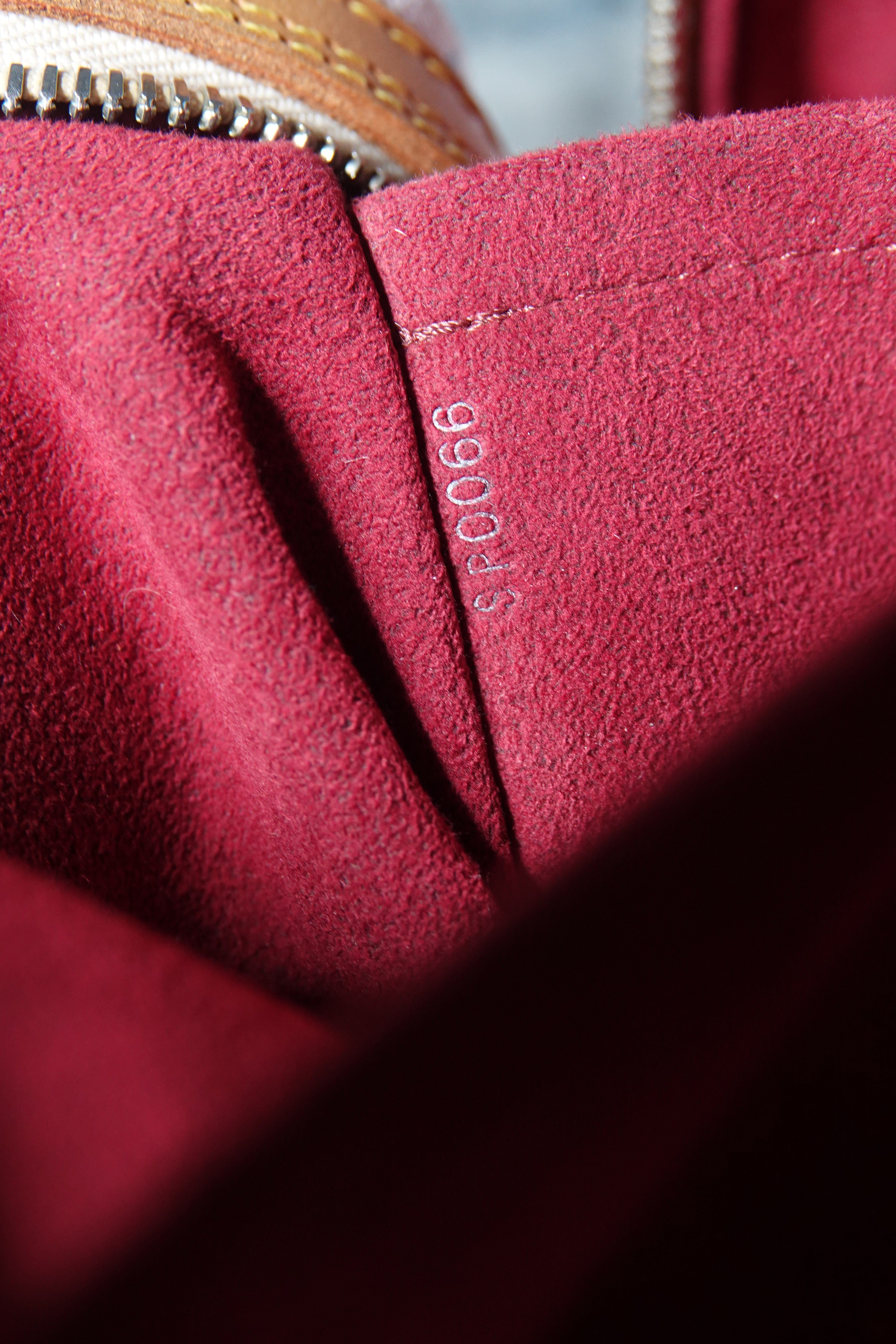 Close-up of a red fabric surface with a visible brand label.