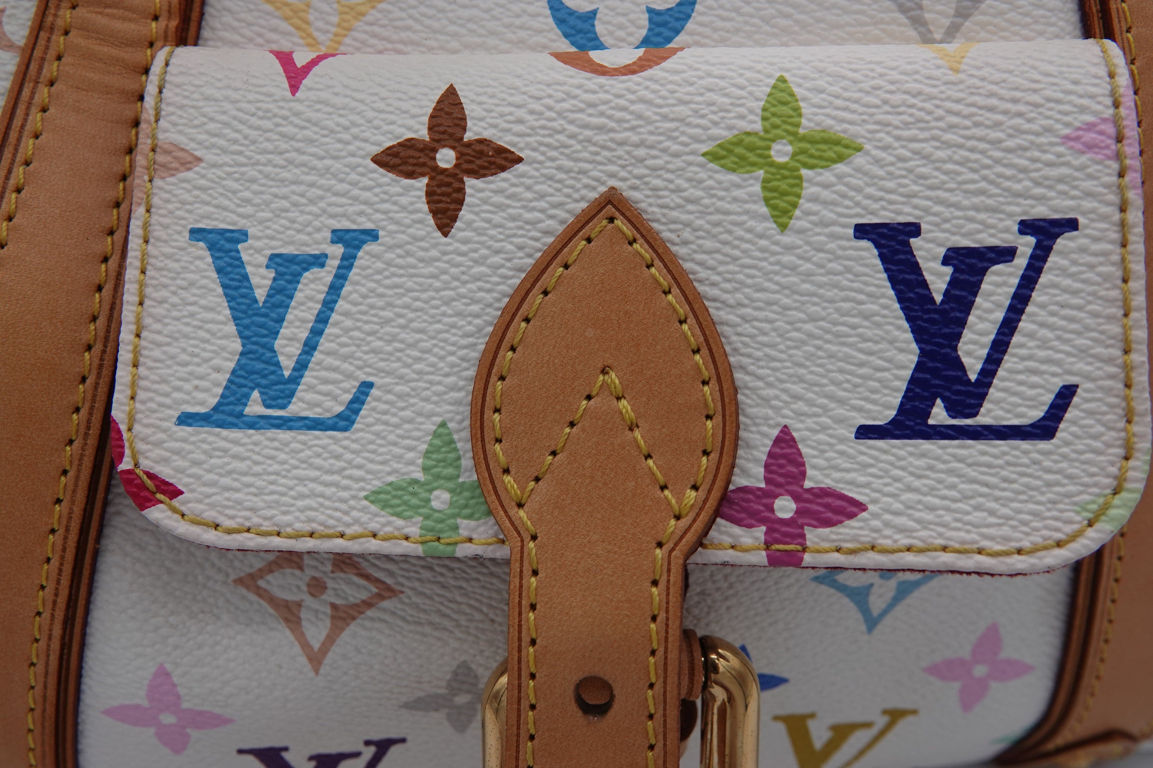 Louis Vuitton handbag with multicolor monogram pattern and brown leather strap.
