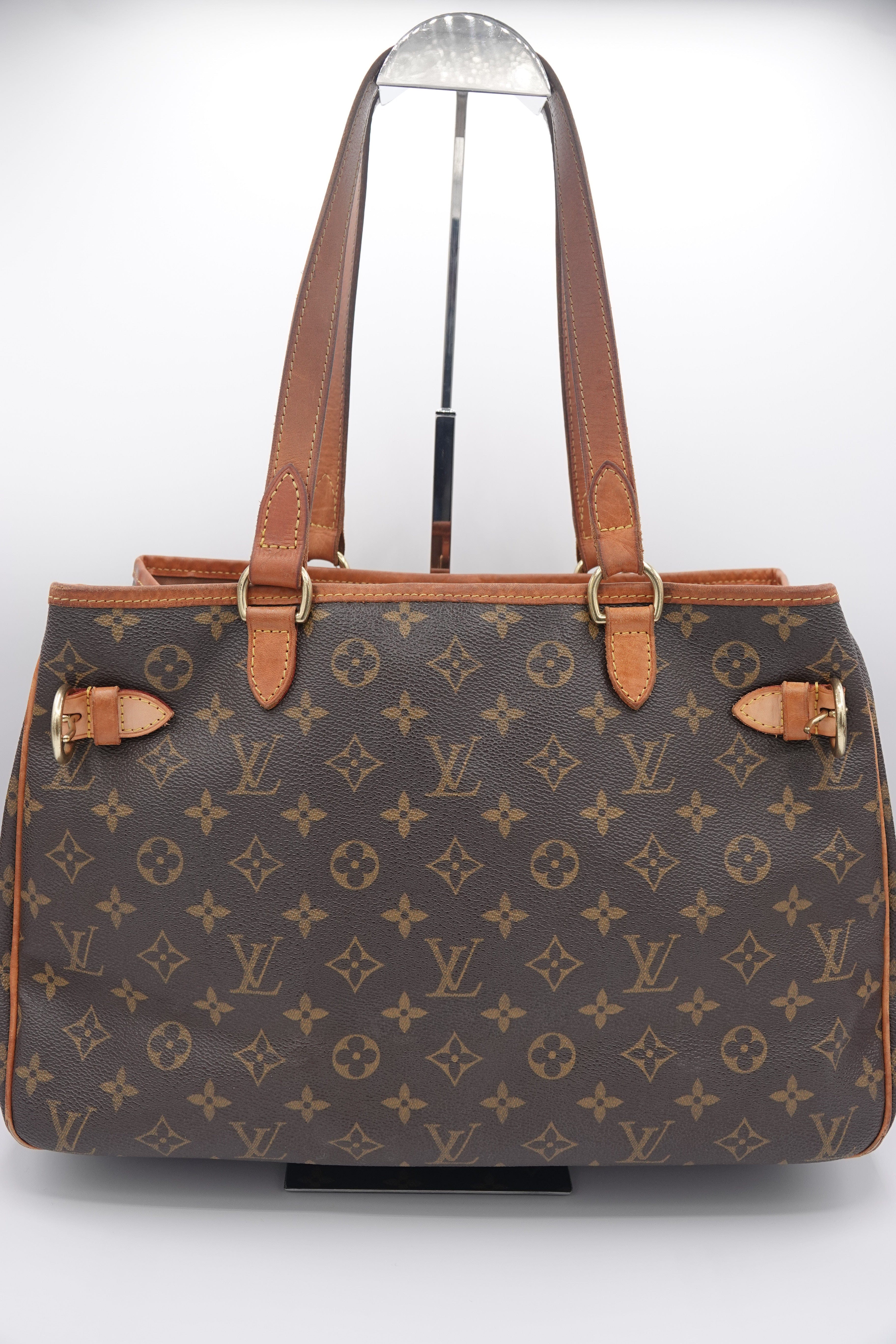 Designer handbag with monogram pattern on a white background