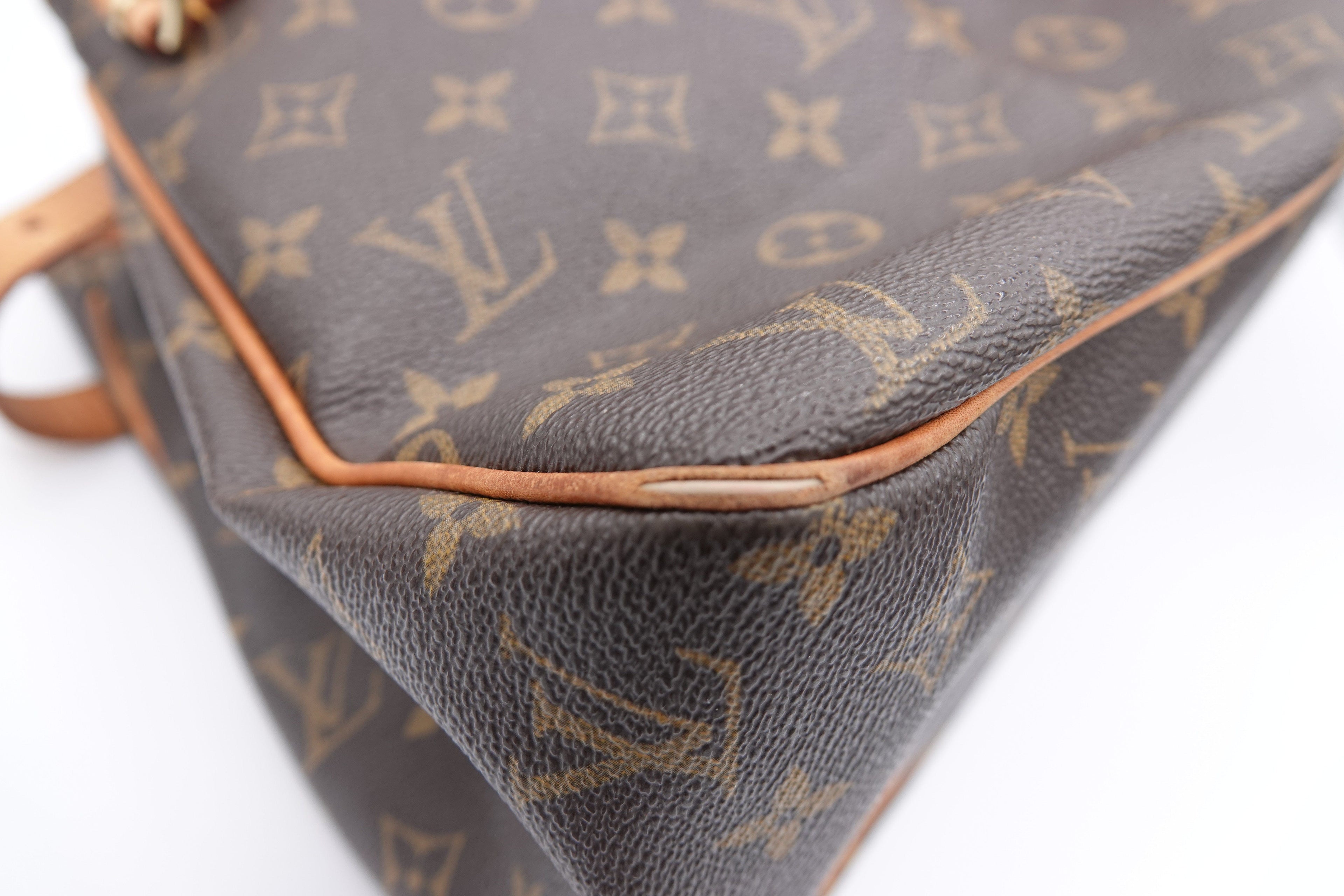 Brown leather Louis Vuitton bag with monogram pattern on a white background