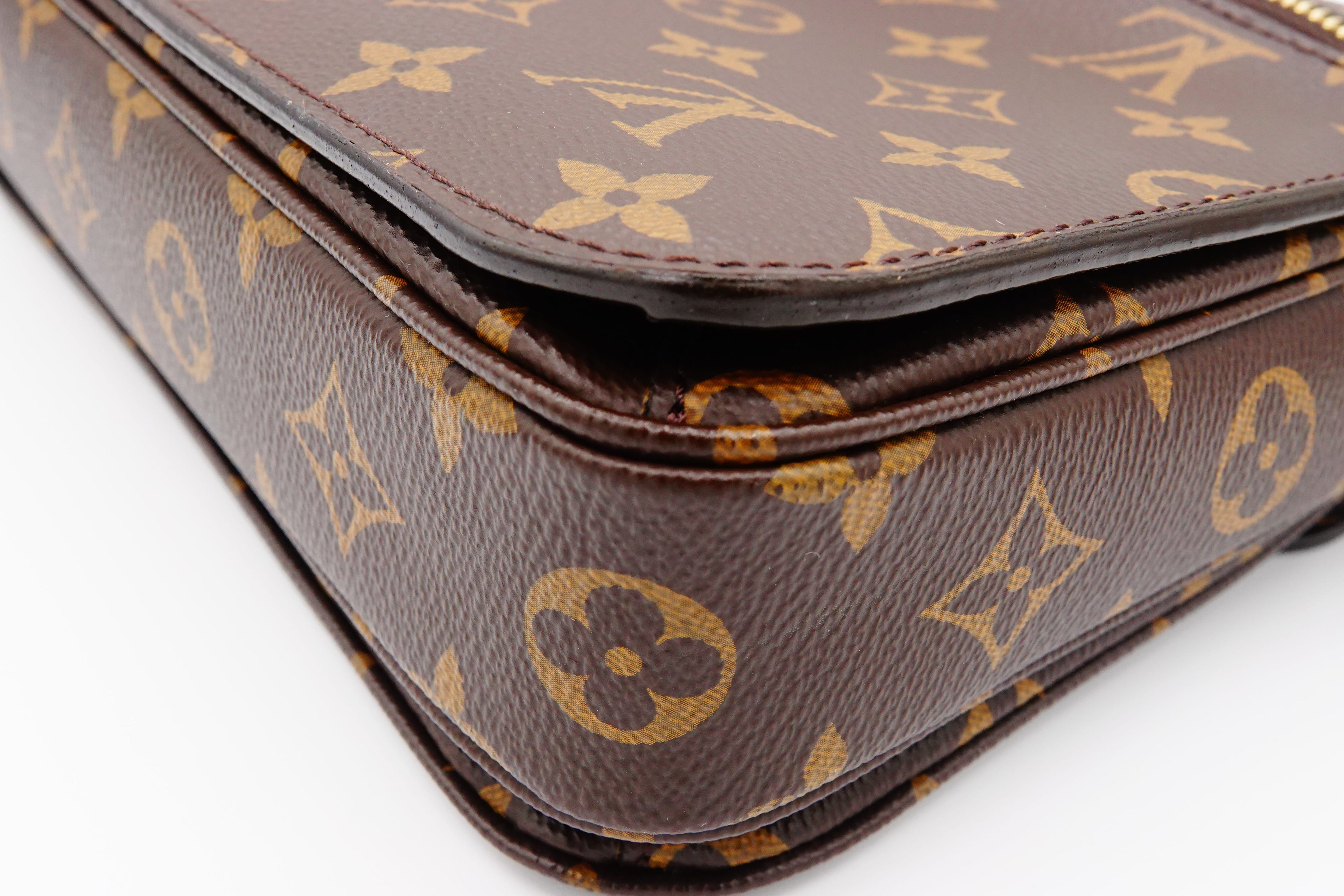 Close-up of a brown leather bag with a distinctive gold pattern on a white background