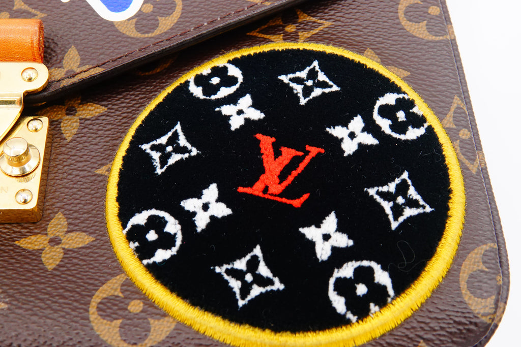 Louis Vuitton patch on a monogrammed handbag