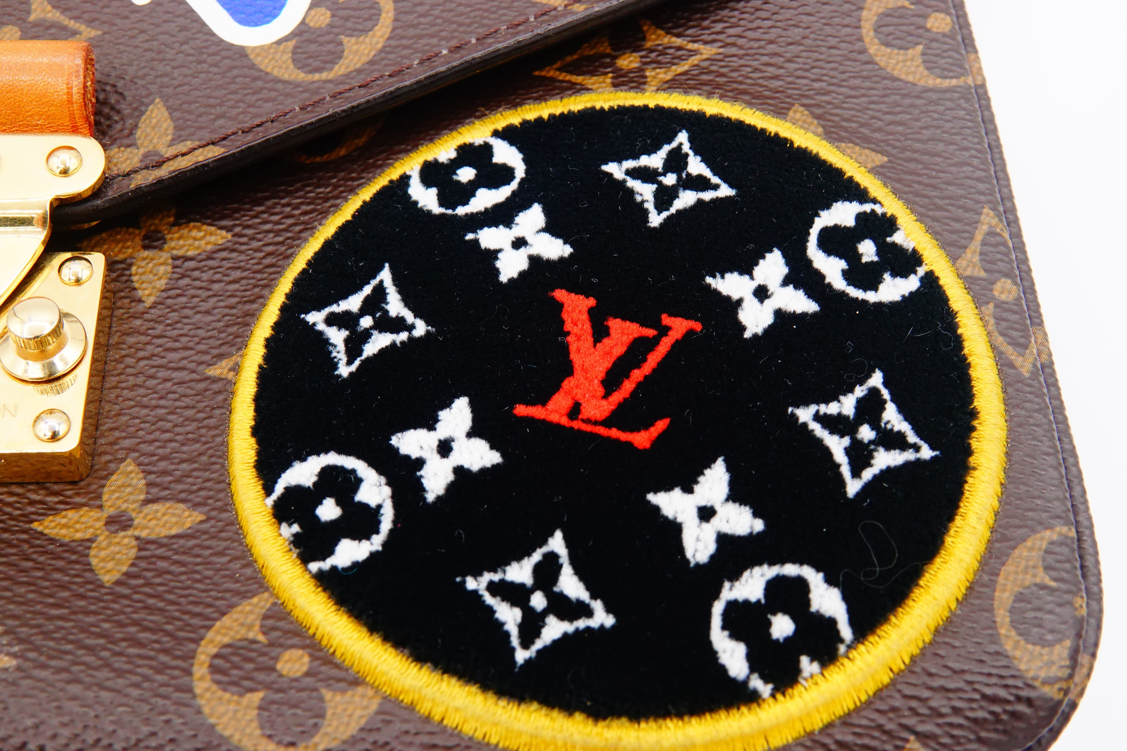 Louis Vuitton patch on a monogrammed handbag