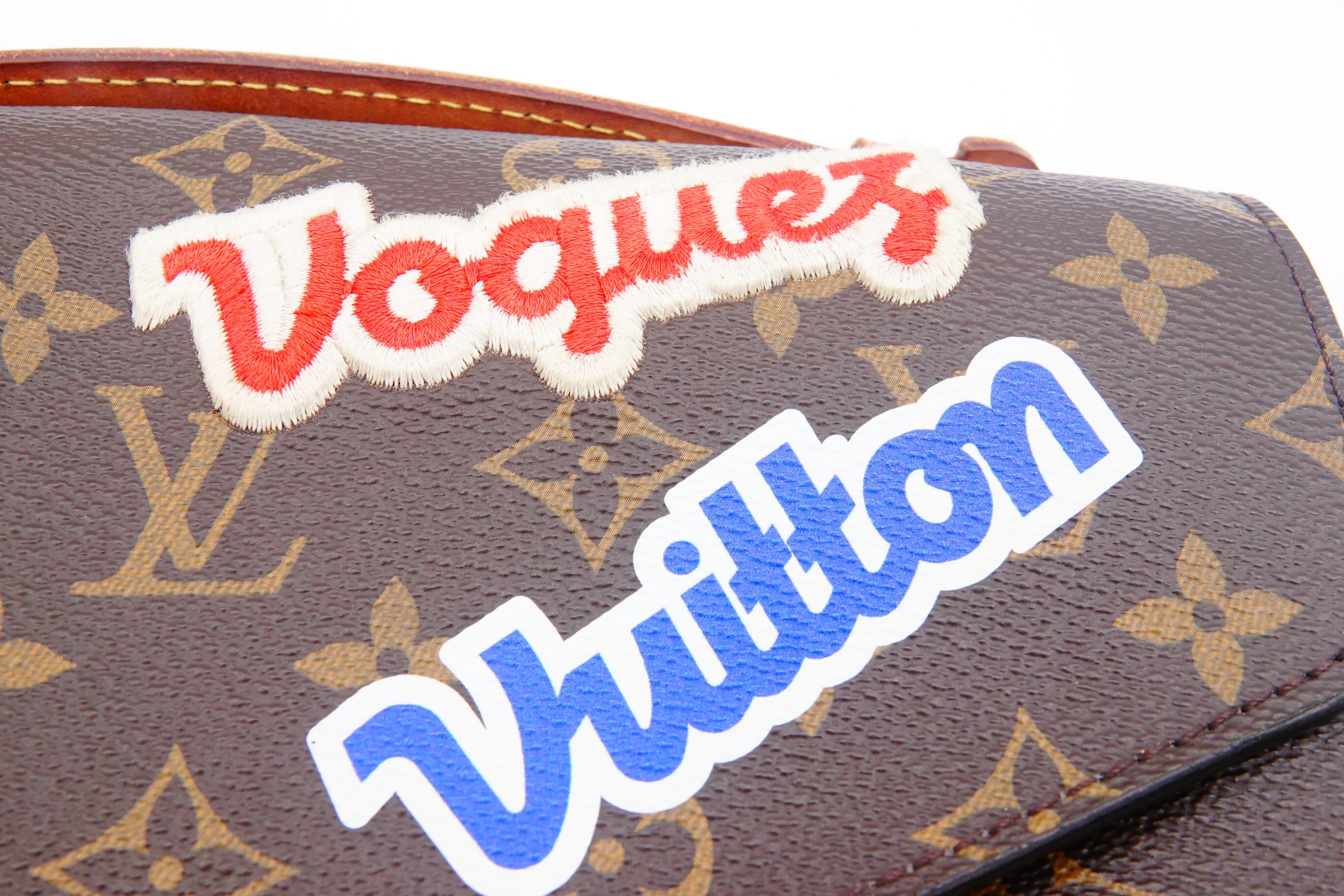 Louis Vuitton bag with 'Vogue' patch on a white background