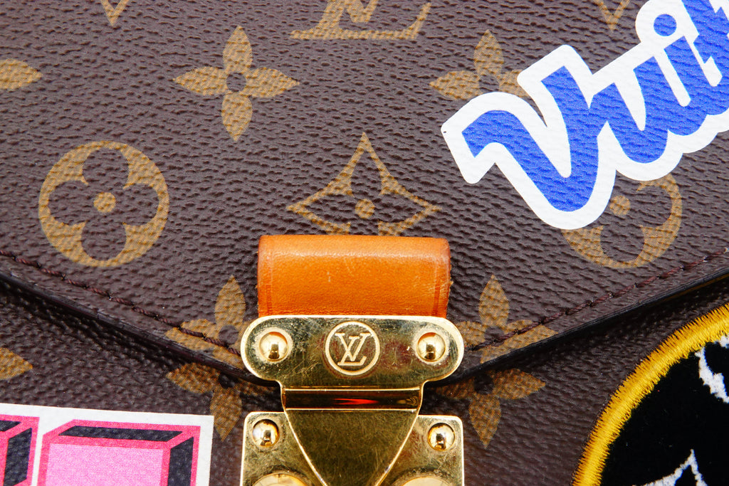 Close-up of a Louis Vuitton handbag with a visible brand logo and 'Wii' branding.