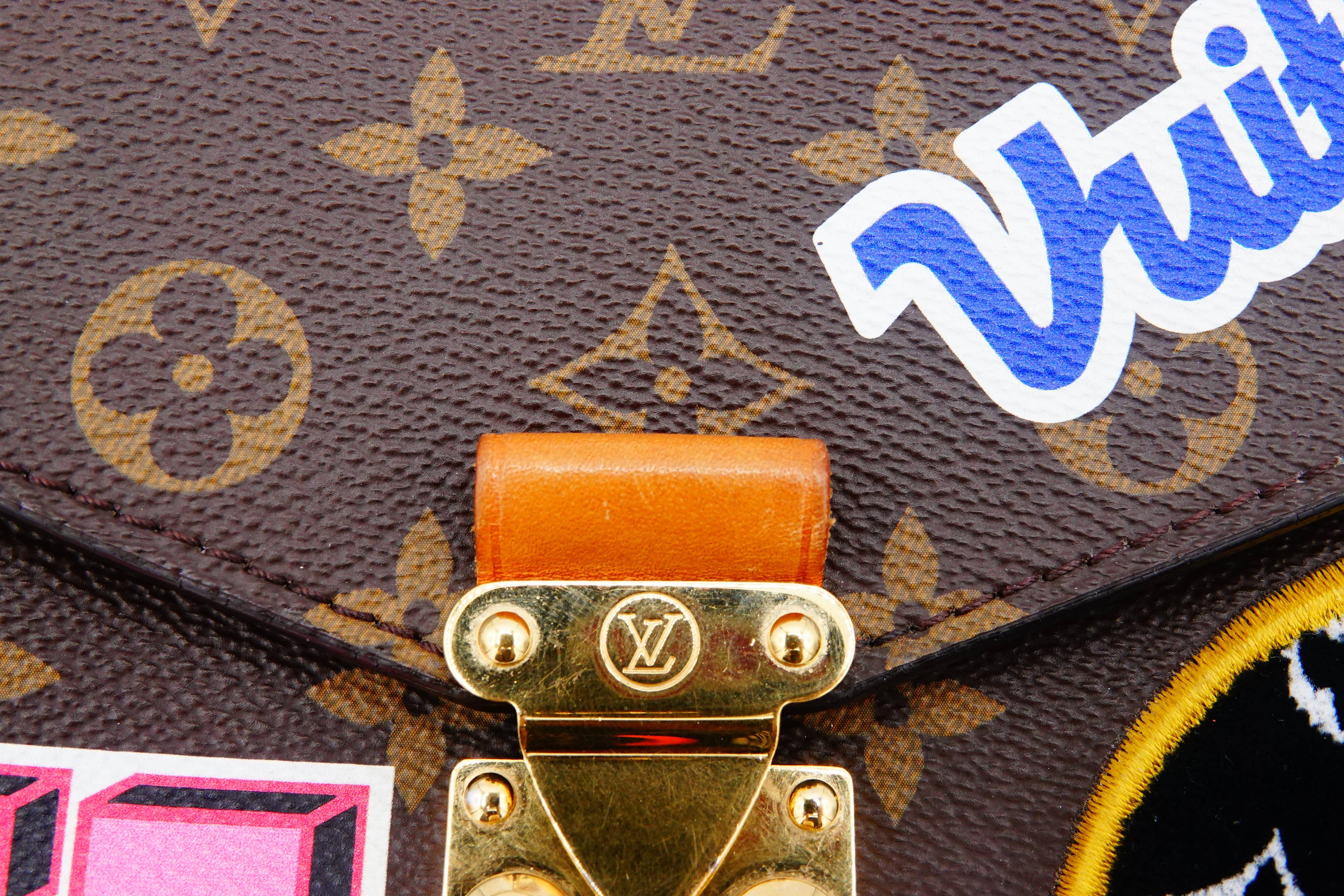 Close-up of a Louis Vuitton handbag with a visible brand logo and 'Wii' branding.