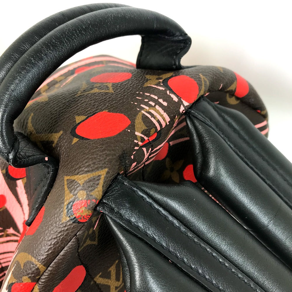 Close-up of a patterned handbag with red and black design on a white background