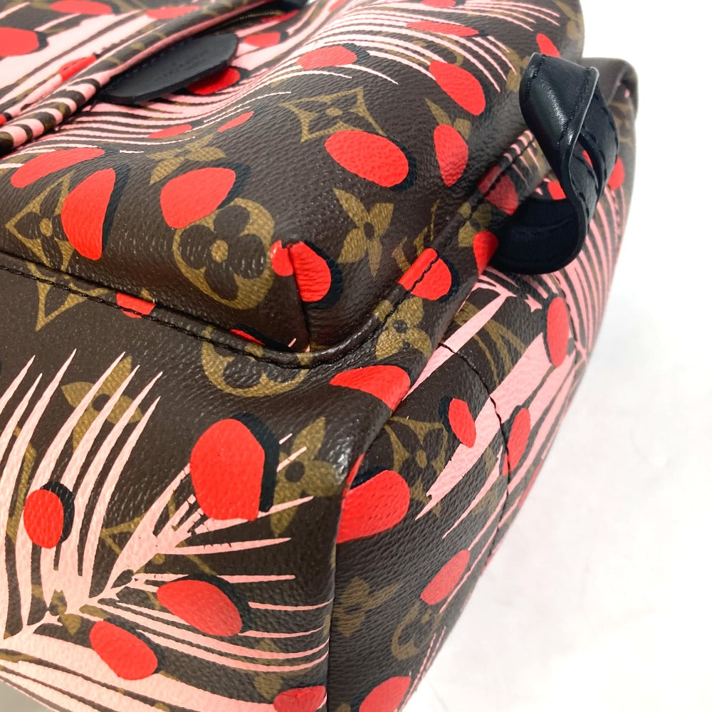 Close-up of a patterned suitcase with red hearts and black background