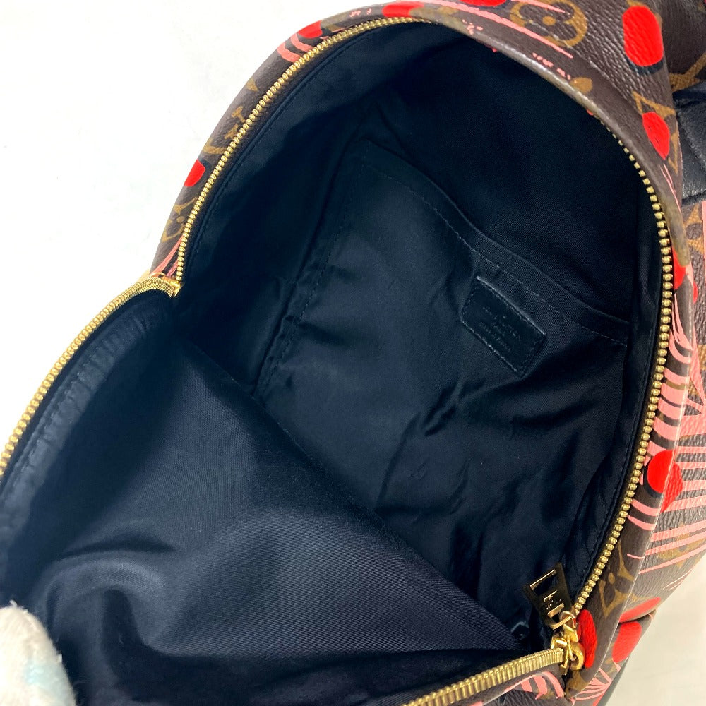 Open backpack with floral pattern on the outside, showing dark interior.