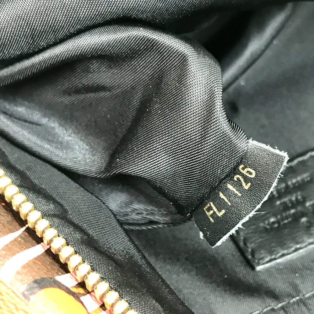 Close-up of a black fabric texture with a visible label on a jacket.