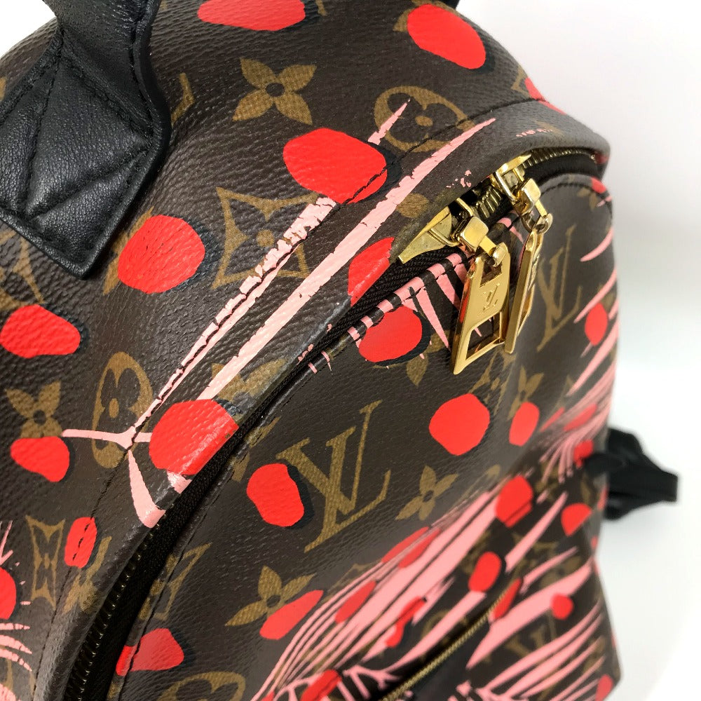 Designer backpack with red heart pattern and gold zipper on a white background