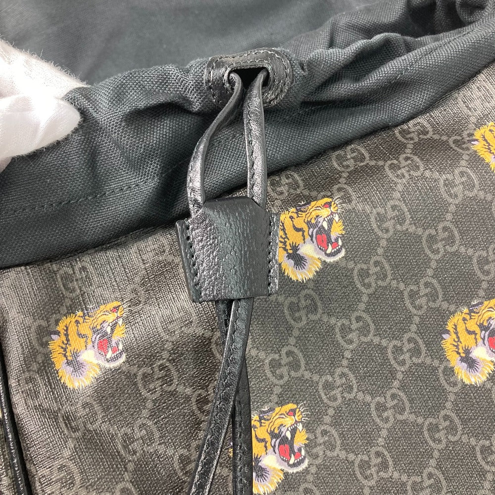 Close-up of a gray fabric with Gucci logo and tiger embroidery
