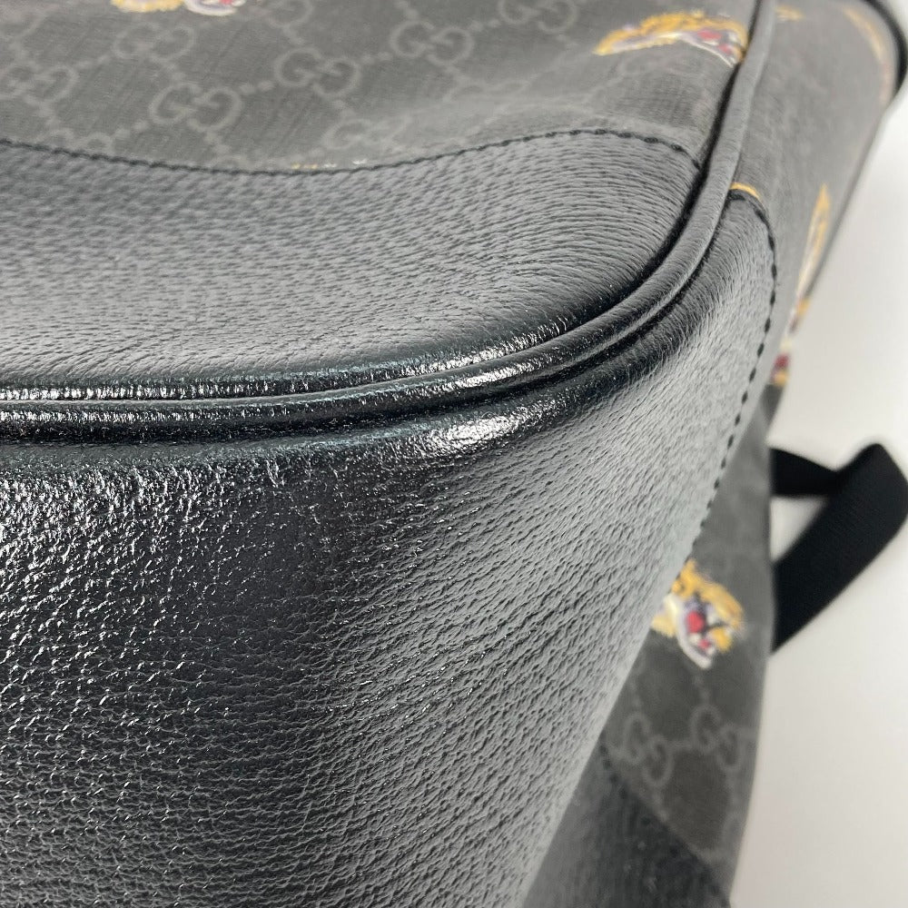 Close-up of a black leather bag with a patterned background