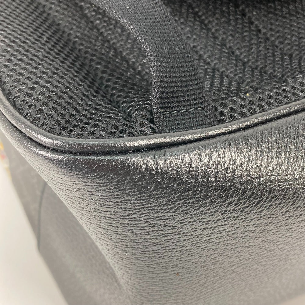 Close-up of a textured black bag corner on a light background