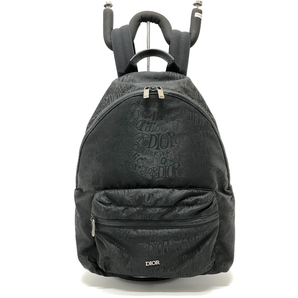 Black backpack with Dior branding on a white background