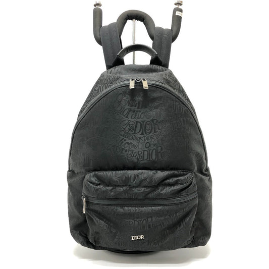 Black backpack with Dior branding on a white background