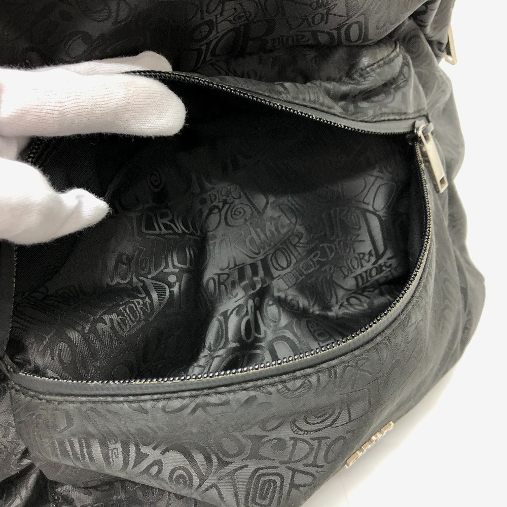Close-up of a black textured bag with visible branding on a white background