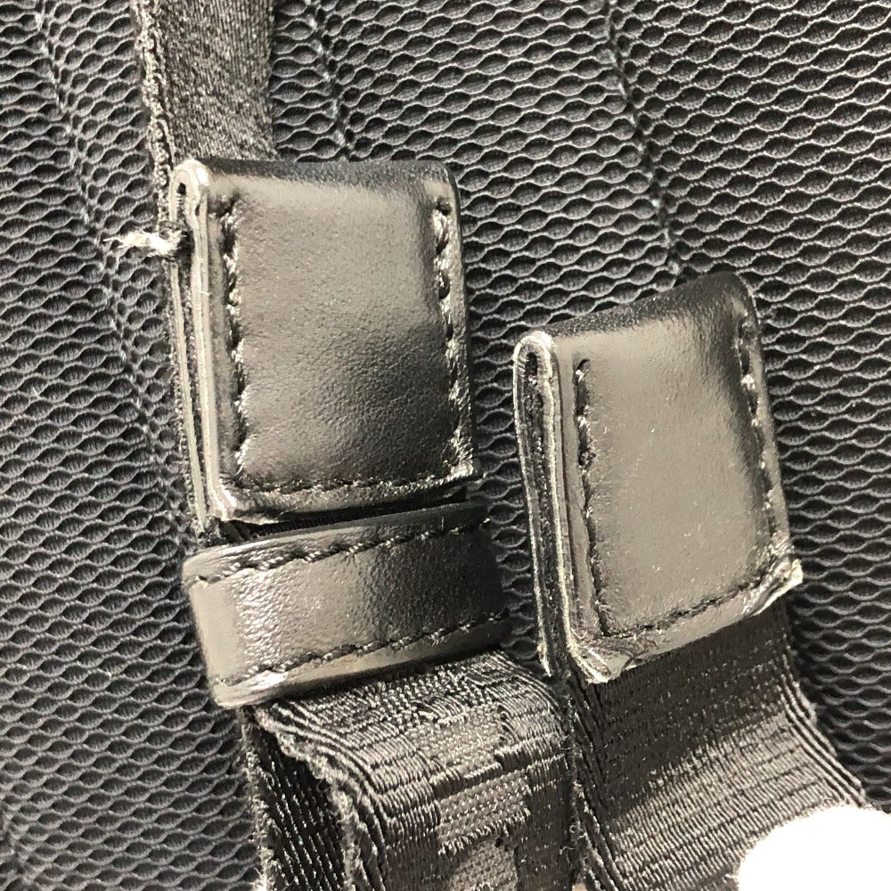 Close-up of black leather straps with stitching on a textured black background