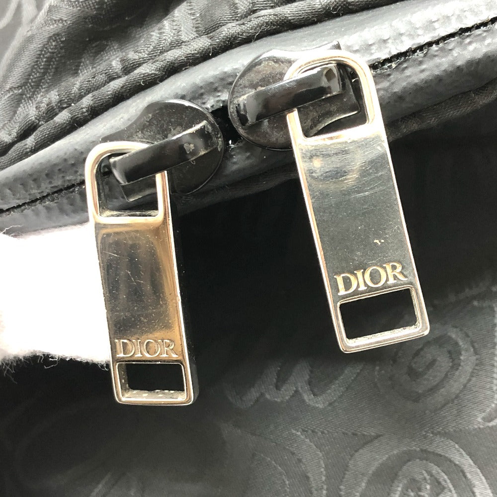 Close-up of Dior bag with gold and silver zippers.