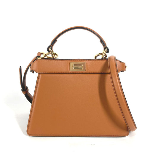 Brown handbag with gold clasp on a white background