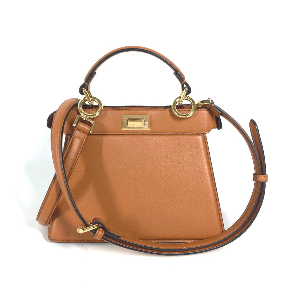Brown handbag with gold accents on a white background