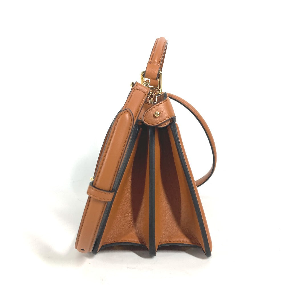 Brown leather handbag with gold hardware on a white background