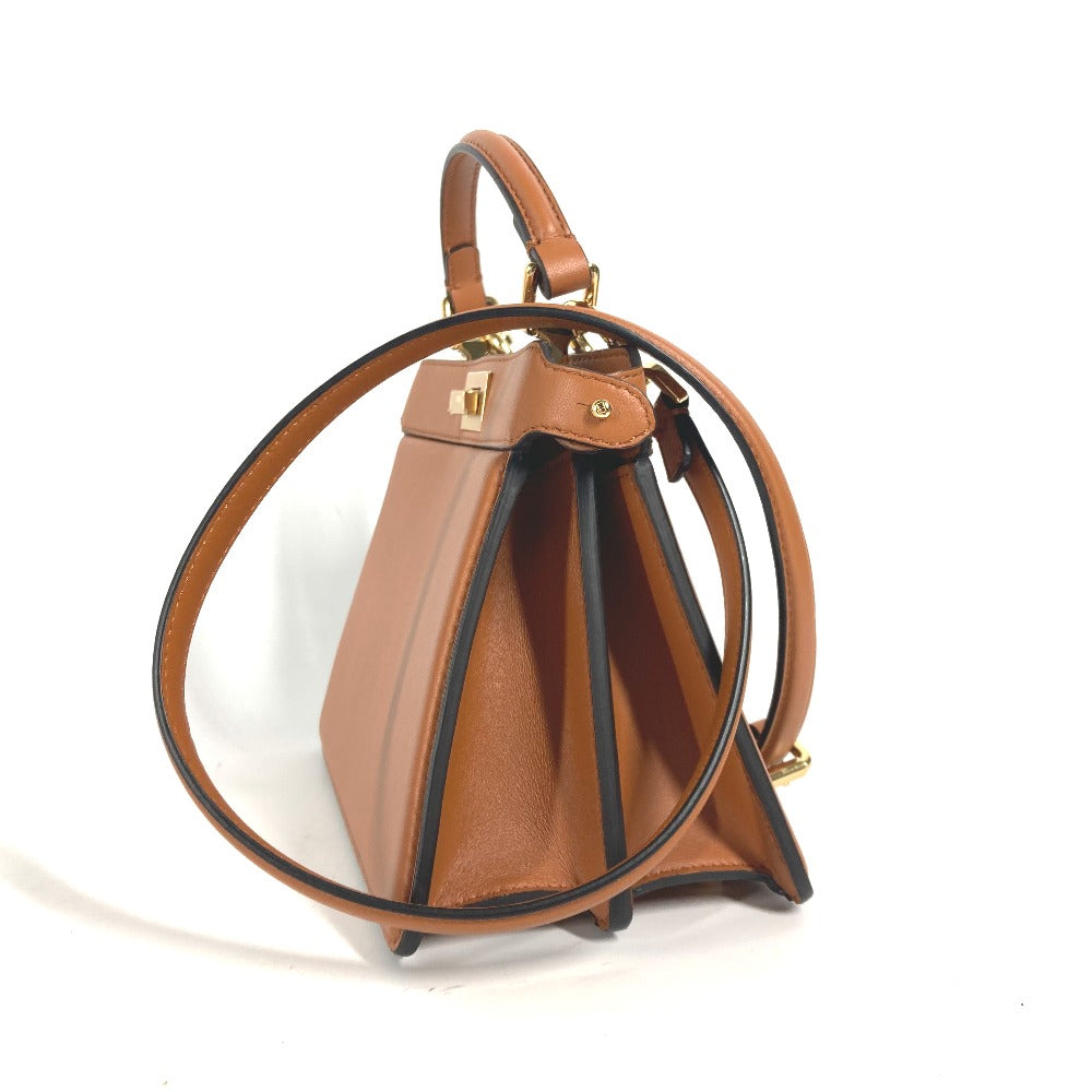 Brown leather handbag with black accents on a white background