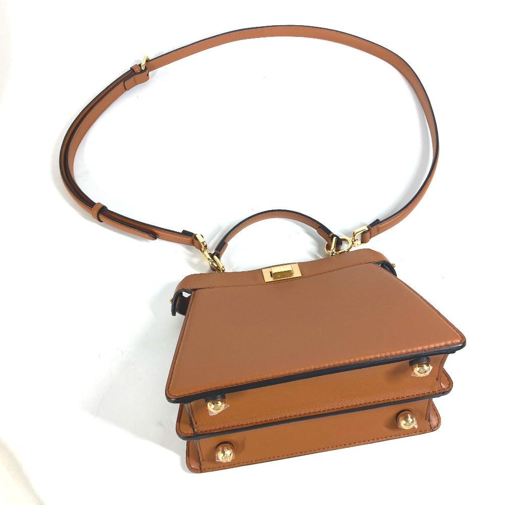 Brown handbag with gold accents on a white background
