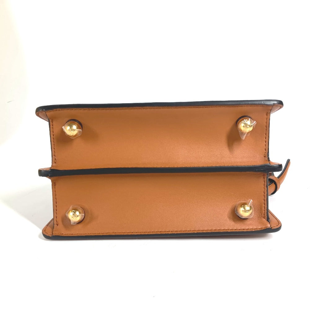 Close-up of a brown leather handbag with gold hardware on a white background