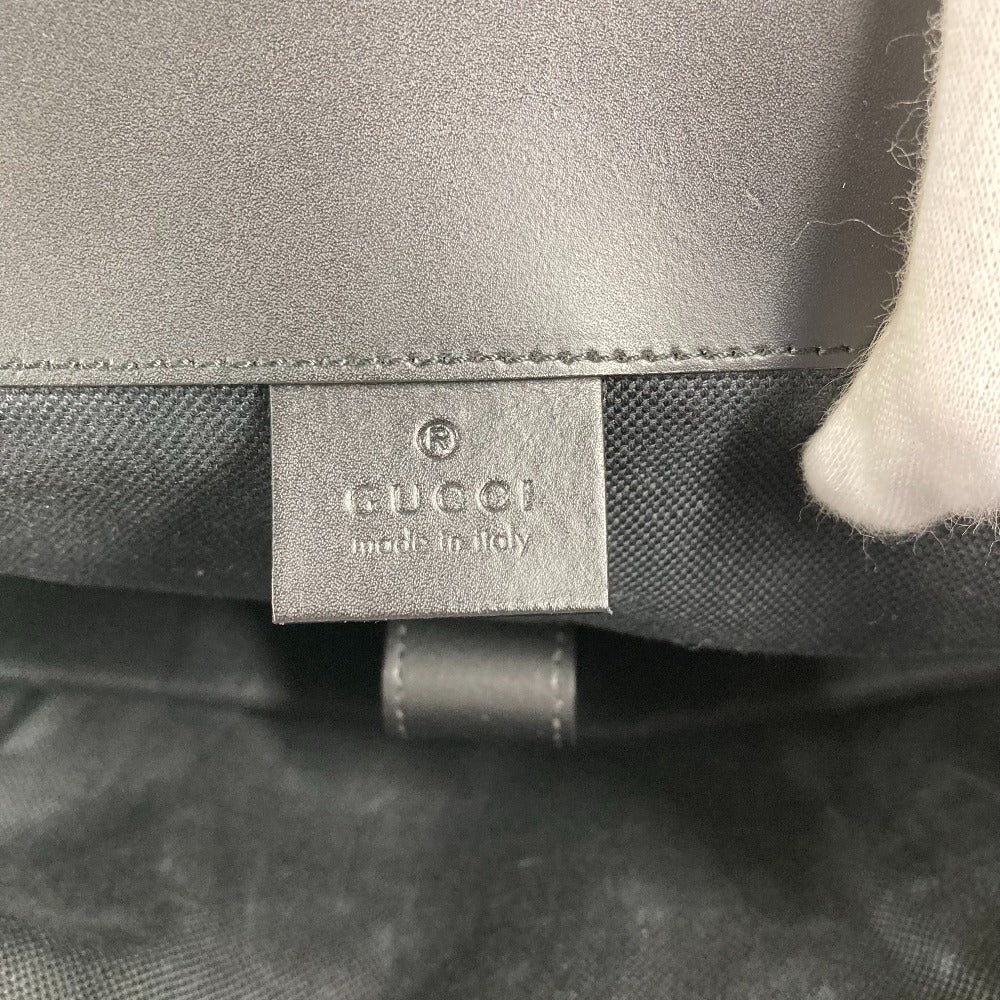 Close-up of a Gucci label on a gray textured surface