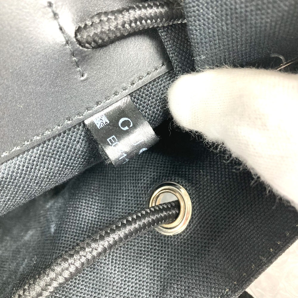 Close-up of a gray bag with a visible brand tag and zipper.