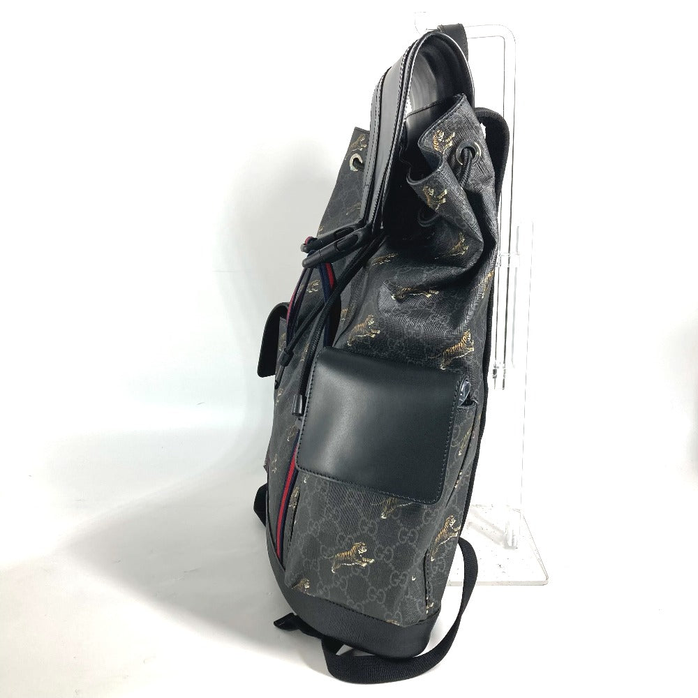Black leather bag with gold embroidery on a white background