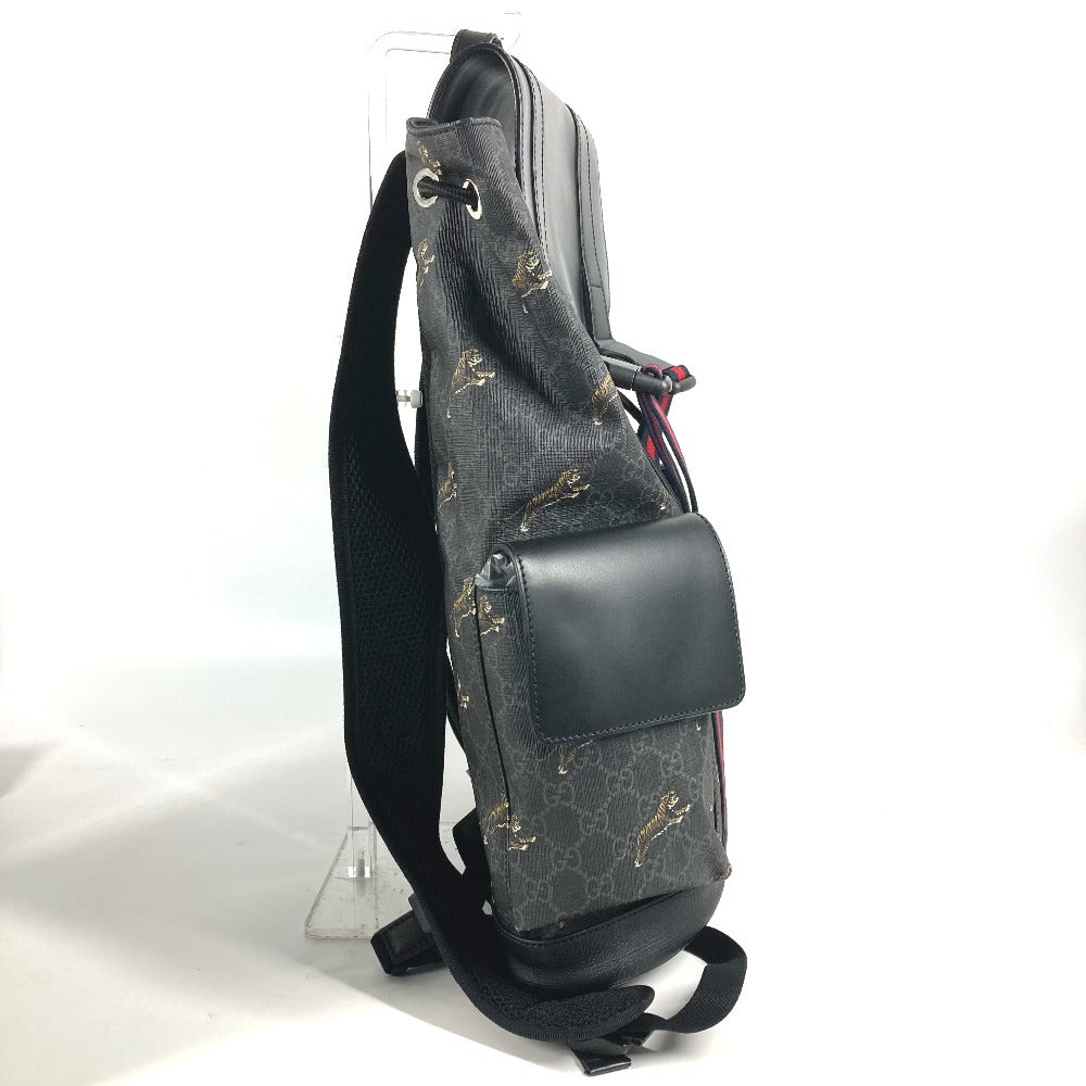 Gray sling bag with black leather pocket on a white background