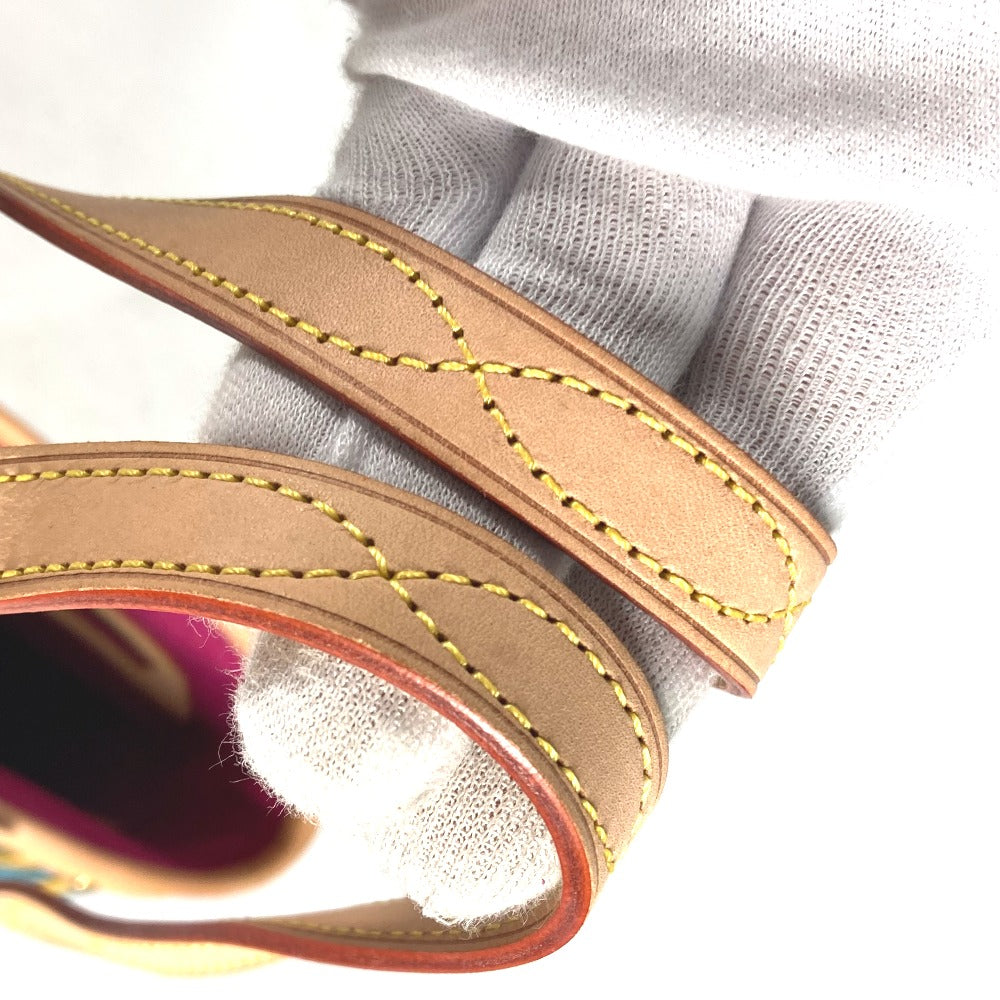 Close-up of a sandal strap with brown leather and yellow stitching on a white background