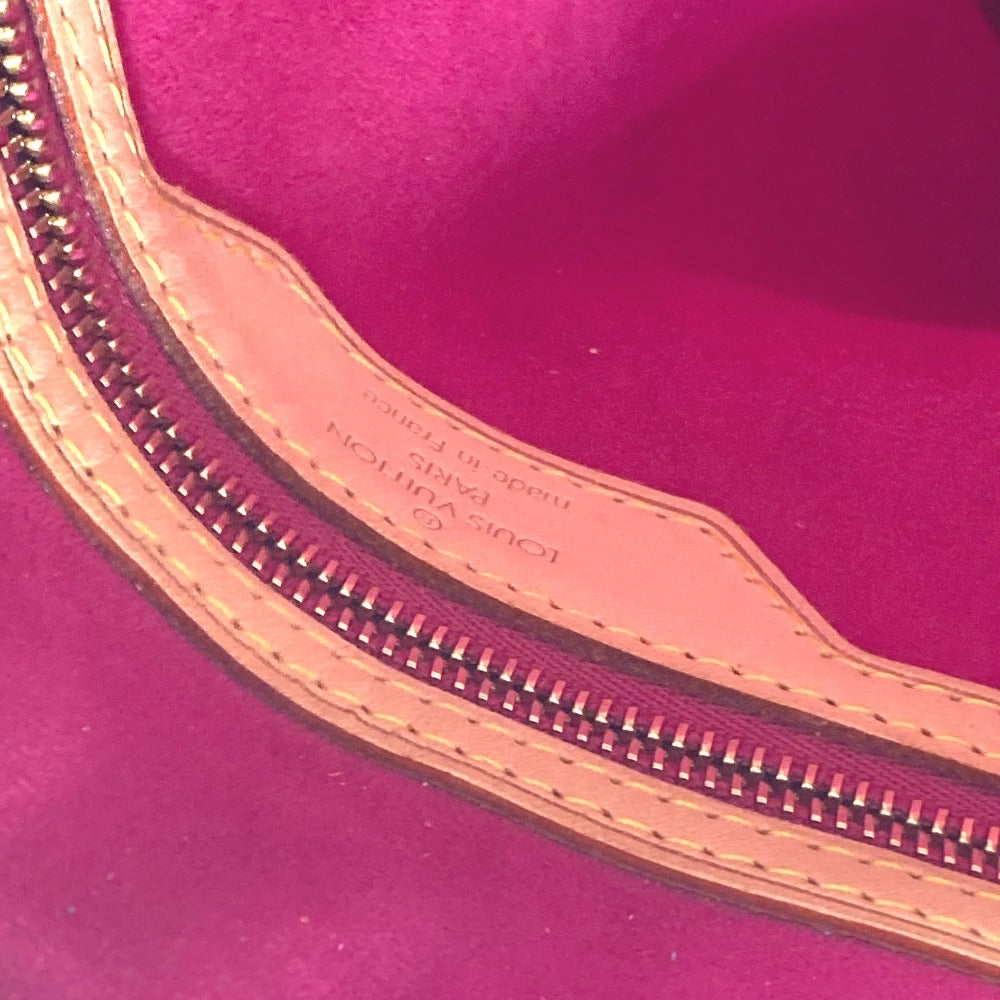 Close-up of a pink Louis Vuitton handbag with visible branding.
