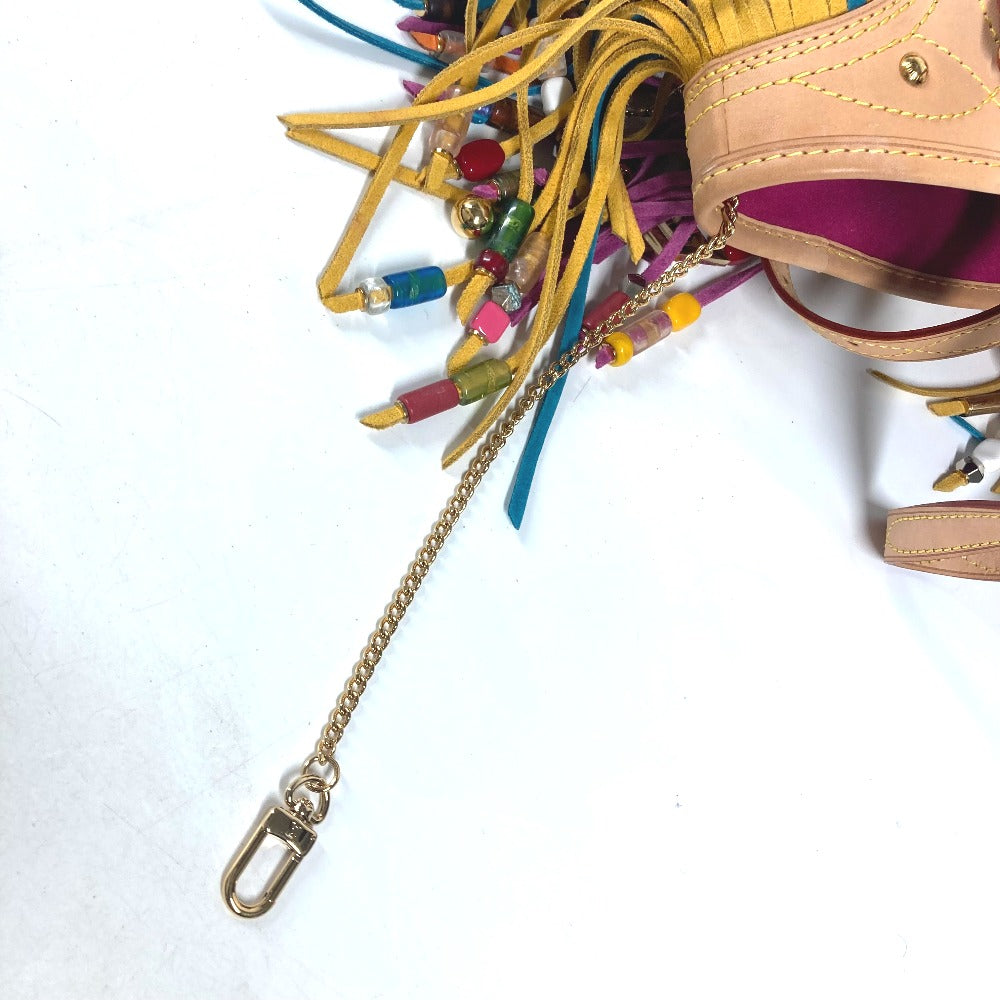 Close-up of a handbag with colorful tassels and a chain strap on a white background