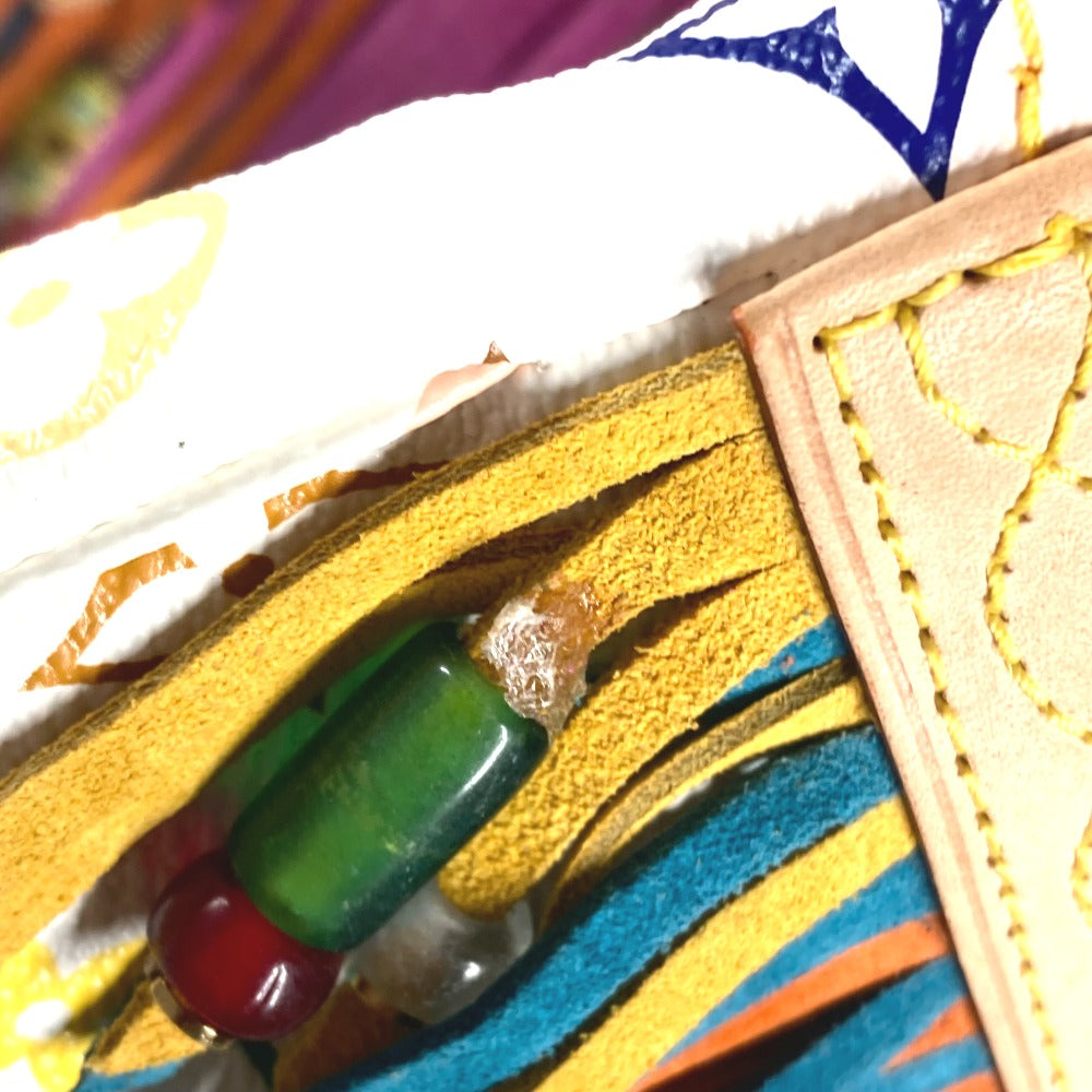 Close-up of a colorful fabric with embroidery and beads
