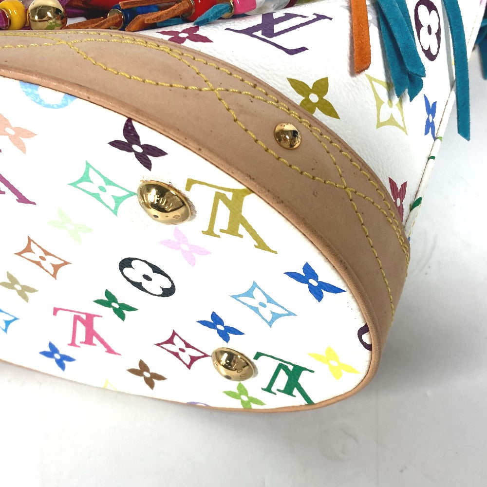 Close-up of a handbag with colorful monogram pattern and gold hardware.