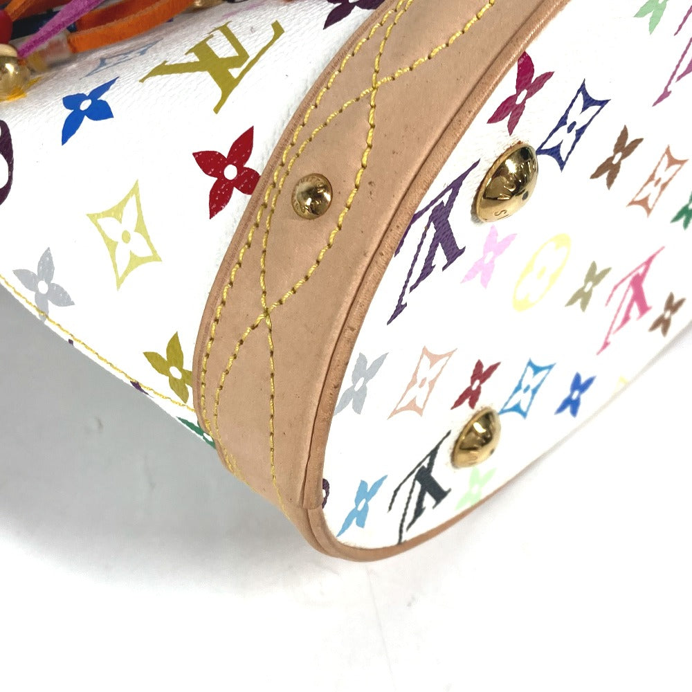 Close-up of a handbag with colorful monogram pattern and gold hardware.