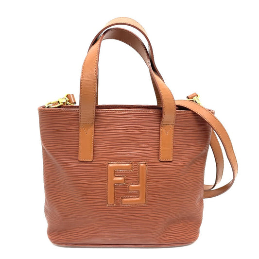 Brown handbag with a prominent logo on a white background