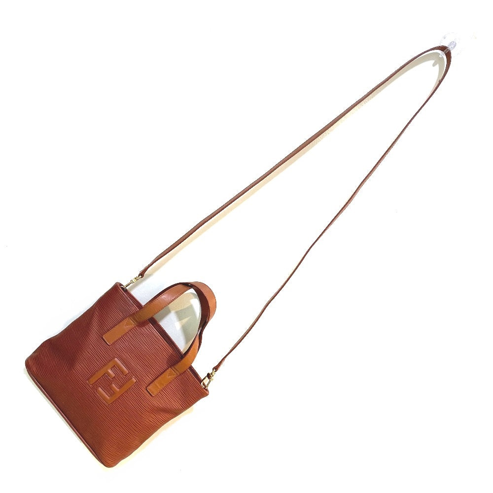 Brown handbag with a visible brand logo on a white background