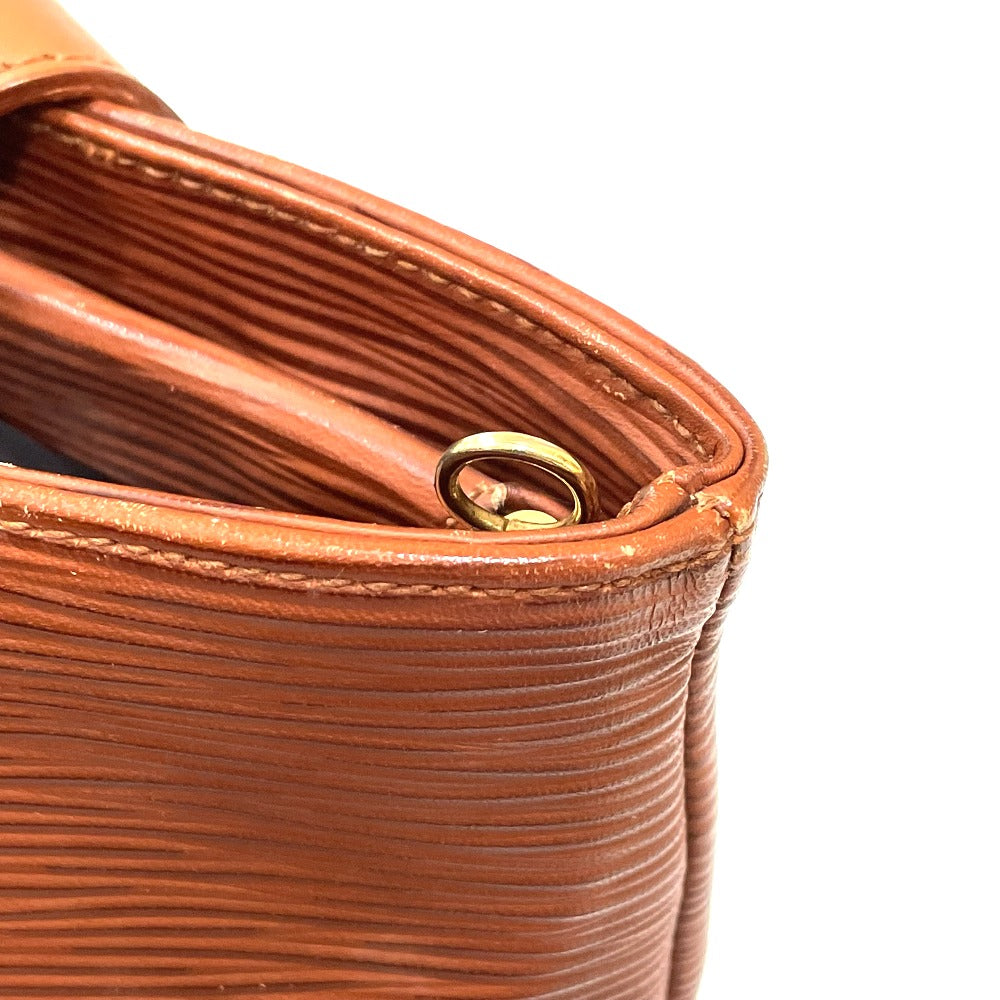 Close-up of a brown textured leather product with a gold clasp on a white background