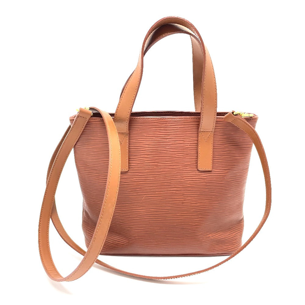 Brown leather handbag with a shoulder strap on a white background