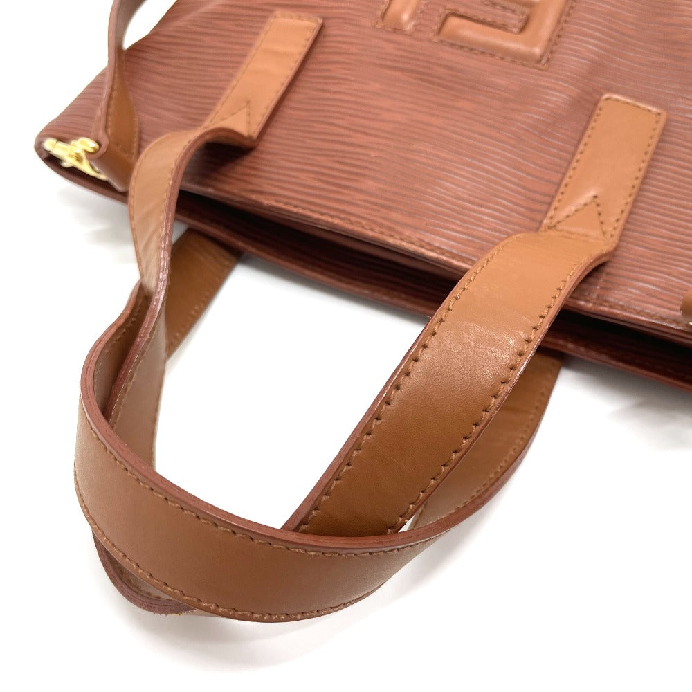 Brown leather handbag with strap on a white background