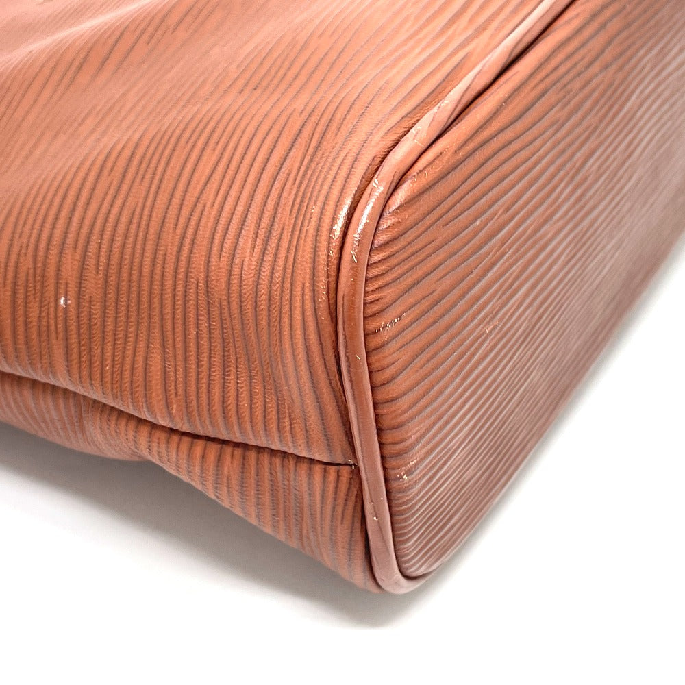 Close-up of a brown textured clutch bag on a white background