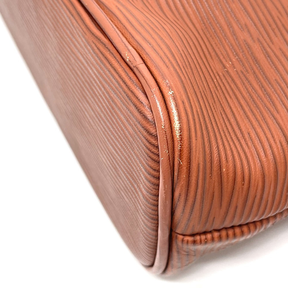 Close-up of a brown textured clutch bag on a white background