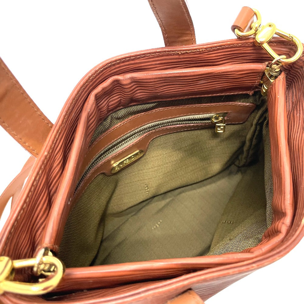 Brown leather handbag with gold hardware on a white background