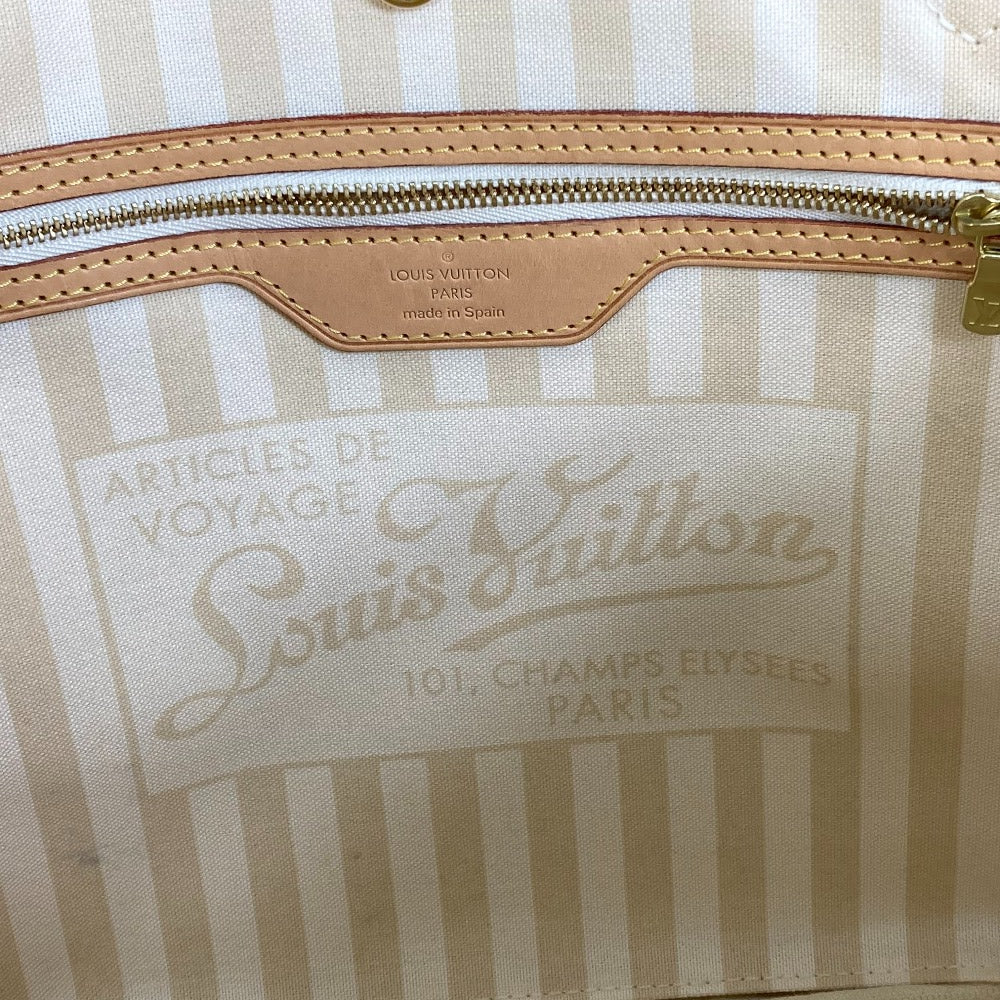 Close-up of a Louis Vuitton bag with a striped pattern and visible brand logo.